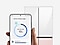 In front of a refrigerator, a hand holds a Galaxy smartphone displaying the AI energy mode SmartThings app UI.