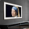 A Samsung Frame television hanging on a wall, showing the artwork of the Girl with the Pearl Earring.