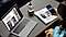 A promotional banner titled “Only with Samsung” displays four exclusive benefits. The first panel promotes the New Galaxy Club with an image of Galaxy devices and a membership badge. The second highlights a trade-in offer with visuals of Samsung monitors and smartphones. The third showcases Samsung Care+ with a phone and monitor representing extended protection and support. The fourth panel advertises Samsung Offer Programs, featuring people using tablets and laptops around a table, with savings available for students, military personnel, and corporate employees.