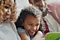 A family gathers around their mobile device