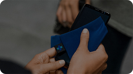 Two pairs of hands exchanging phones