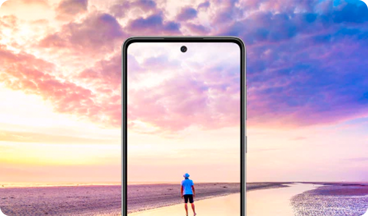 Through the overlay of a Galaxy phone, we see a person enjoys the ocean on a beautiful beach at dusk.