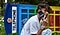 Jaden Smith talking on Z Flip4 in front of an overturned multicolored telephone booth.