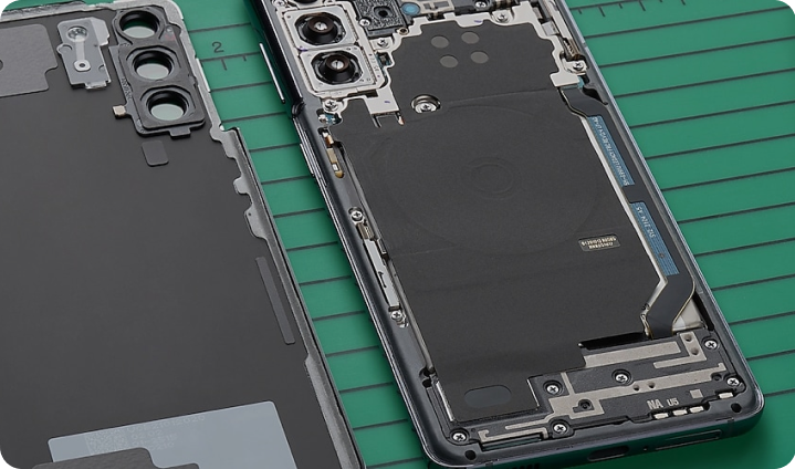 Two Galaxy phones side by side with their covers off, revealing the components beneath.