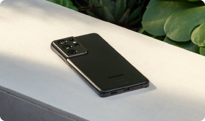 A Galaxy device lays screen-down on a console table.