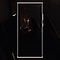 A woman in a darkly lit space with her arms crossed, framed by the outline of a Note20.