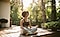 A woman sits outdoors in a meditative pose with her eyes closed. She sits cross-legged on a wooden deck, surrounded by potted plants and trees.