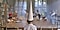 A scene from Sha Mo's film Kids of Paradise, in which a young boy wears a large pointed cone hat in a classroom with other children.