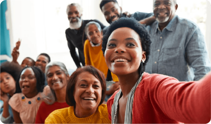 Shot like a selfie, a woman takes a photo of her with her friends and family.