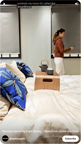 We see a girl take her Galaxy S23 Ultra off the SmartThings Station as she tells us she's going to show us how this little box controls her room. She removes the phone and her blinds begin to open automatically, her lights turn on,  her work station turns on, her air purifier turns on and also her Air Dresser — all  part of the program she created with help from Samsung. She then sits at her desk and gets ready for the day, putting makeup on with the light nearby. As she gets ready the Air Dresser refreshes her jackets - we see her pull it out of the device. She sits at her work station in her now fresh jacket. We see her connect her phone to her monitor with Multi-view. We see it appear on her monitor and she starts work for the day.