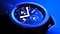 A close up of the face of the Galaxy Watch4, glowing against a dark blue nighttime shot.