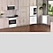 Bespoke Microwave, Induction Range, 4-Door Flex™ Refrigerator and Dishwasher in White Glass in a kitchen with tan cabinets.