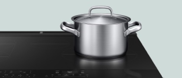 Pot on an induction cooktop with digital controls