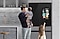 Man with small children in front of Bespoke 4-Door French Door Refrigerator with AI Family Hub™+