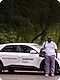 Samsung employee stands outside in front of white Samsung-branded service vehicle