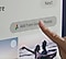 Person using AI Family Hub touchscreen on refrigerator