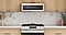 Stainless Steel Over-the-Range Microwave and Range among wood cabinets