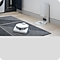 White Robot Vacuum Cleaner on Gray Carpet