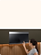 Woman pushes buttons on Stainless Steel Over-the-Range Microwave