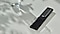 We see the SolarCell Remote near a glass of water on a countertop