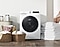 Compact capacity front load washer dryer surrounded by laundry