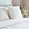 Hai chiếc gối màu trắng đặt trên giường theo lối trang trí kiểu Anh.g on bed with english country style bedding decoration.