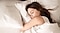 Close up of woman asleep in bed