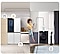 A woman is sitting on the counter of a kitchen that turns into a bathroom counter, merging the two living spaces. She is holding her phone, to which all the appliances are connected, as indicated by white lines and device icons.