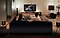 A couple escapes into a movie in their living room, complete with Samsung TV and Soundbar.