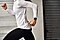A woman mid-run, you can only see her body from the neck down and above the knees