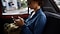 Woman in a car safe surfing on her phone