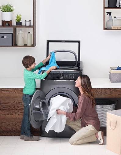 3. A mother and her son use the FlexWash in the laundry room. 