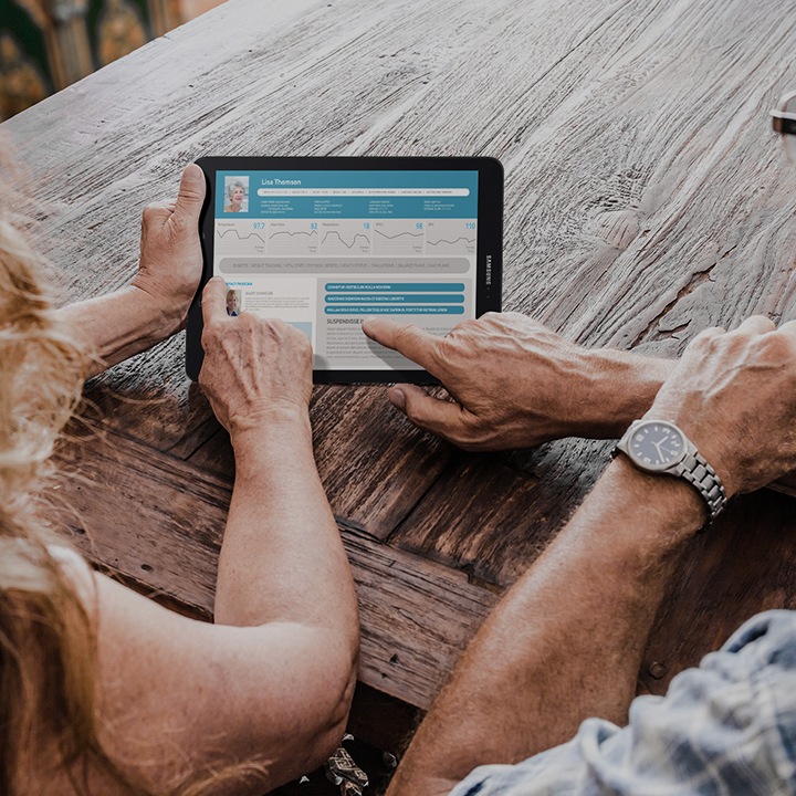 Two seniors checking healthcare information on a Samsung tablet