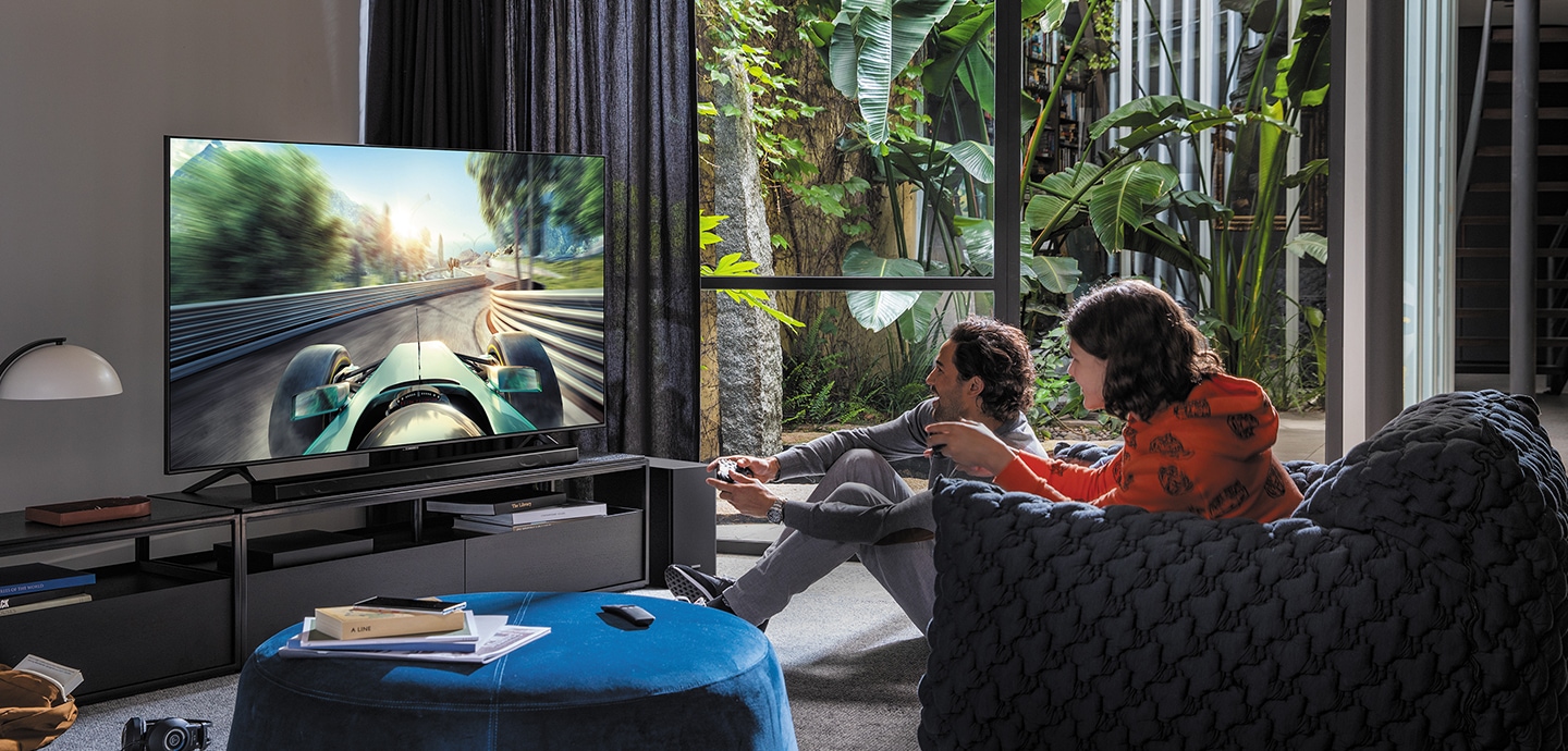 A man and women are playing a game on Samsung Smart TV.