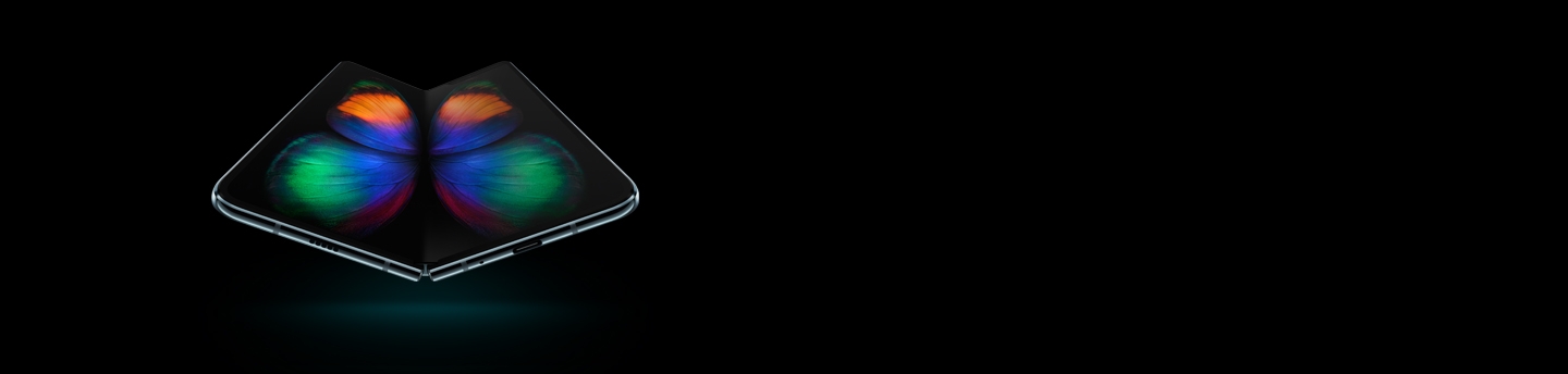 Galaxy Fold in Space Silver seen at a slight angle from the bottom, unfolded, with a multicolor butterfly graphic on-screen.