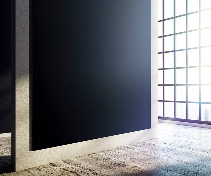 A bezel-less, seamless The Wall display mounted right up against a simple beige wall to show the slimness of the screen