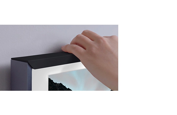 The Frame TV can be customized according to personal tastes and this image shows a person changing the frame color.