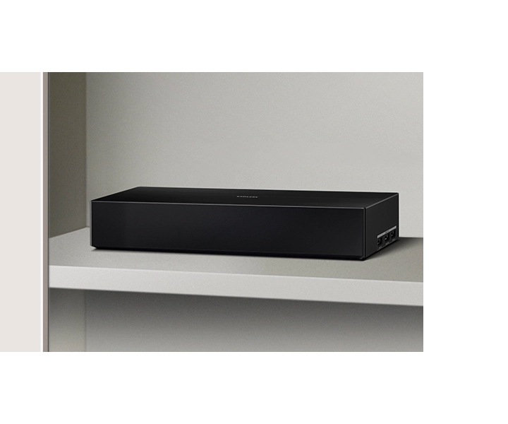 This is a close-up shot of the One Connect Box and Blu-ray player in a cabinet.