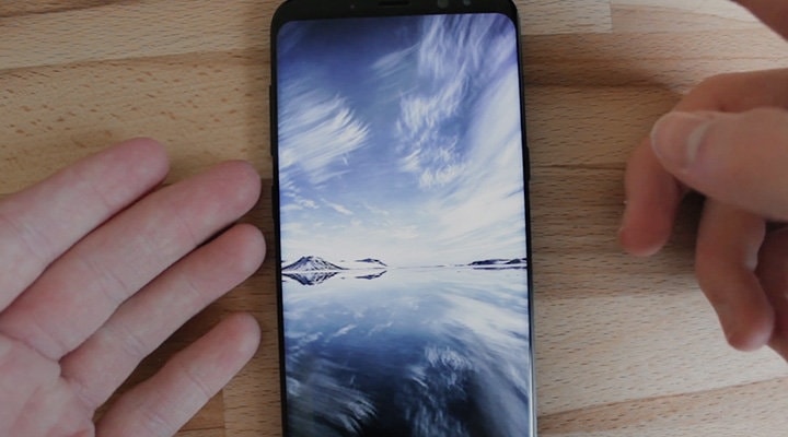 Click to play a video with reviews A front view of Galaxy S8 Midnight Black with running landscape photograph