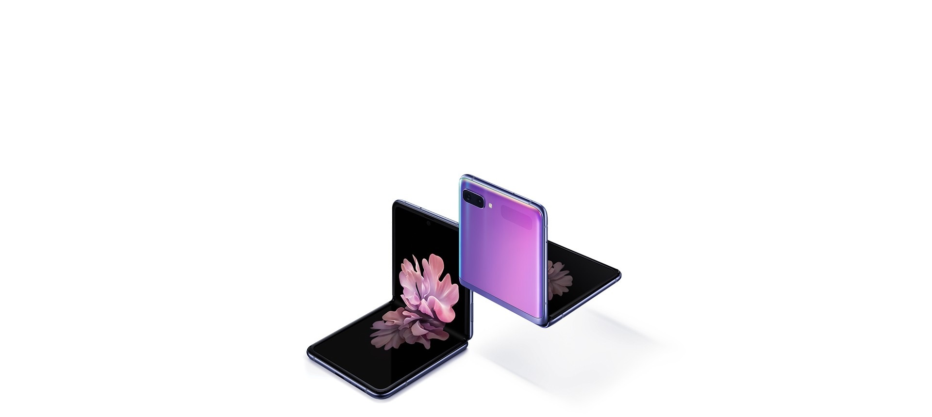 Two Galaxy Z Flip phones in Mirror Purple at a three-quarter angle, one seen from the front and one seen from the rear. Both are folded at right angles with freestop folding. The one seen from the front has the blossoming flower wallpaper onscreen