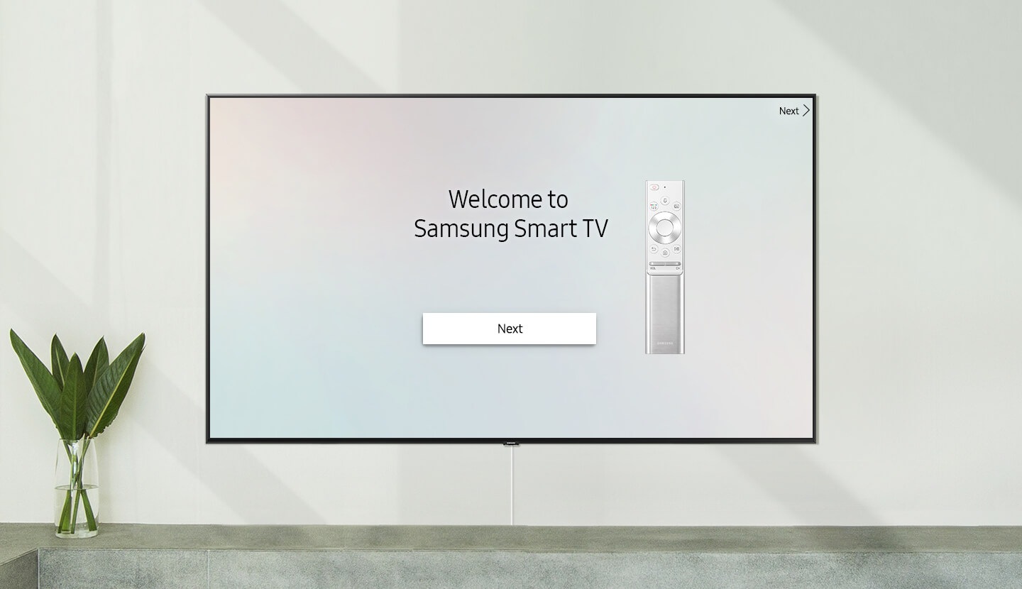 Smart TV colocada na parede com a ecrã de boas vindas; "Bem-vindo à Samsung Smart TV" com um Controlo Remoto Único.