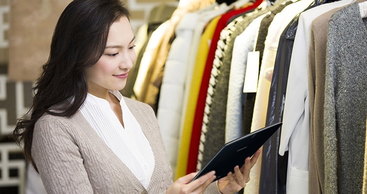 A customer instantly checking further information about clothes using Samsung tablet