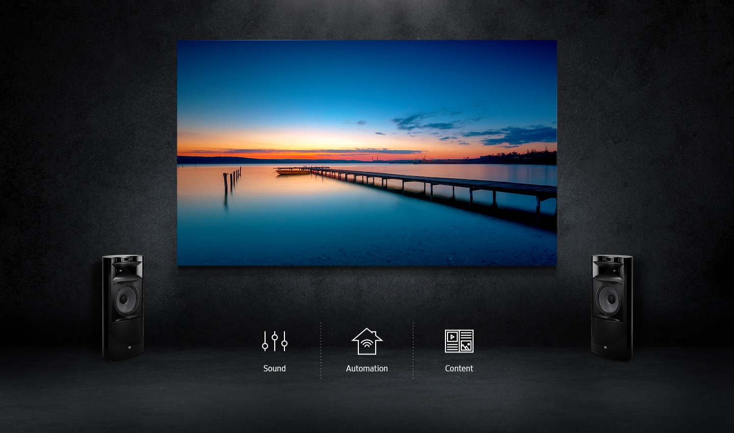 The Wall against a simple black background with a set of luxury floor standing speakers. The Wall in a residential setting provides total ecosystem including sound, home automation and content.