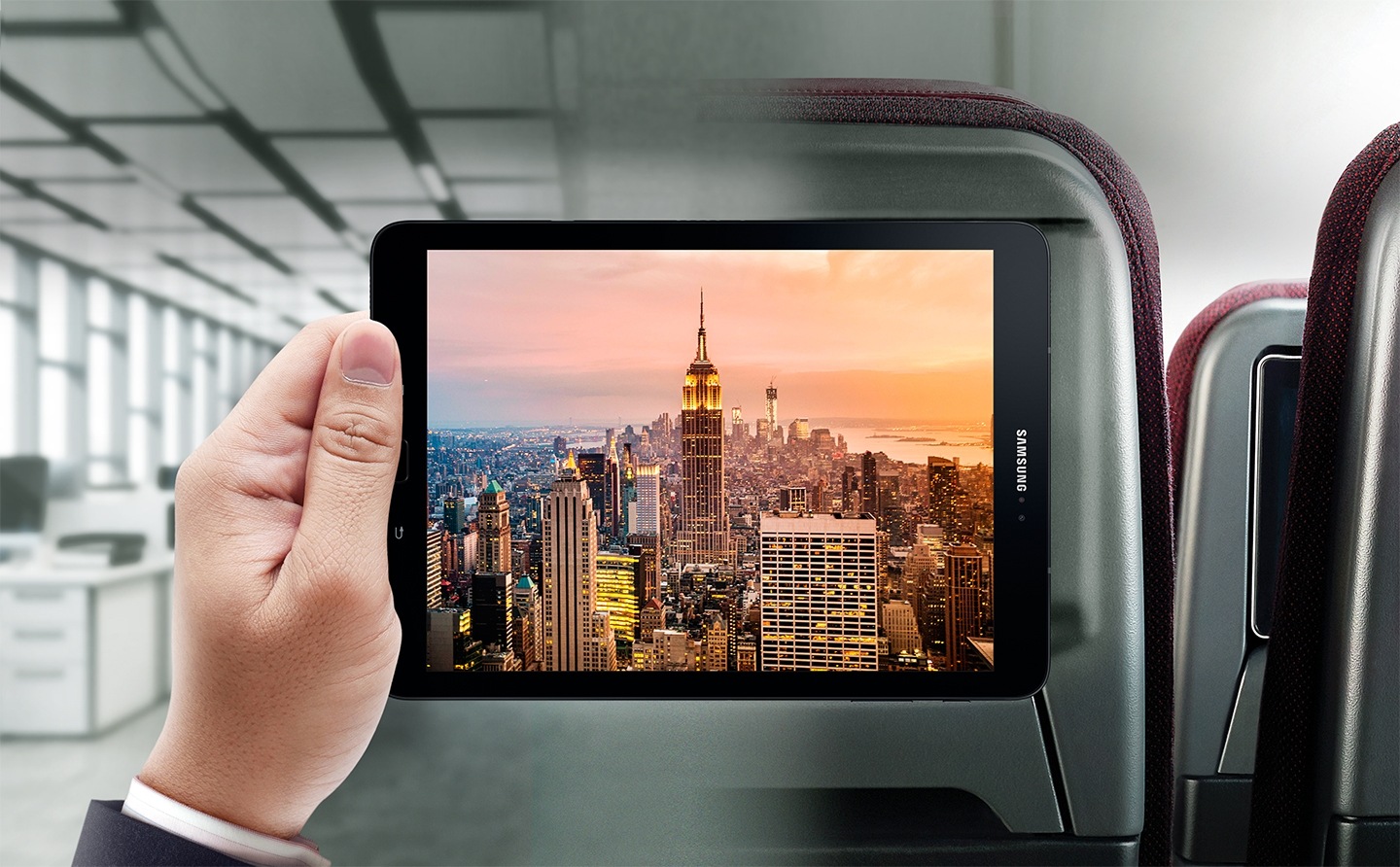 Man holding tablet on Qantas plane