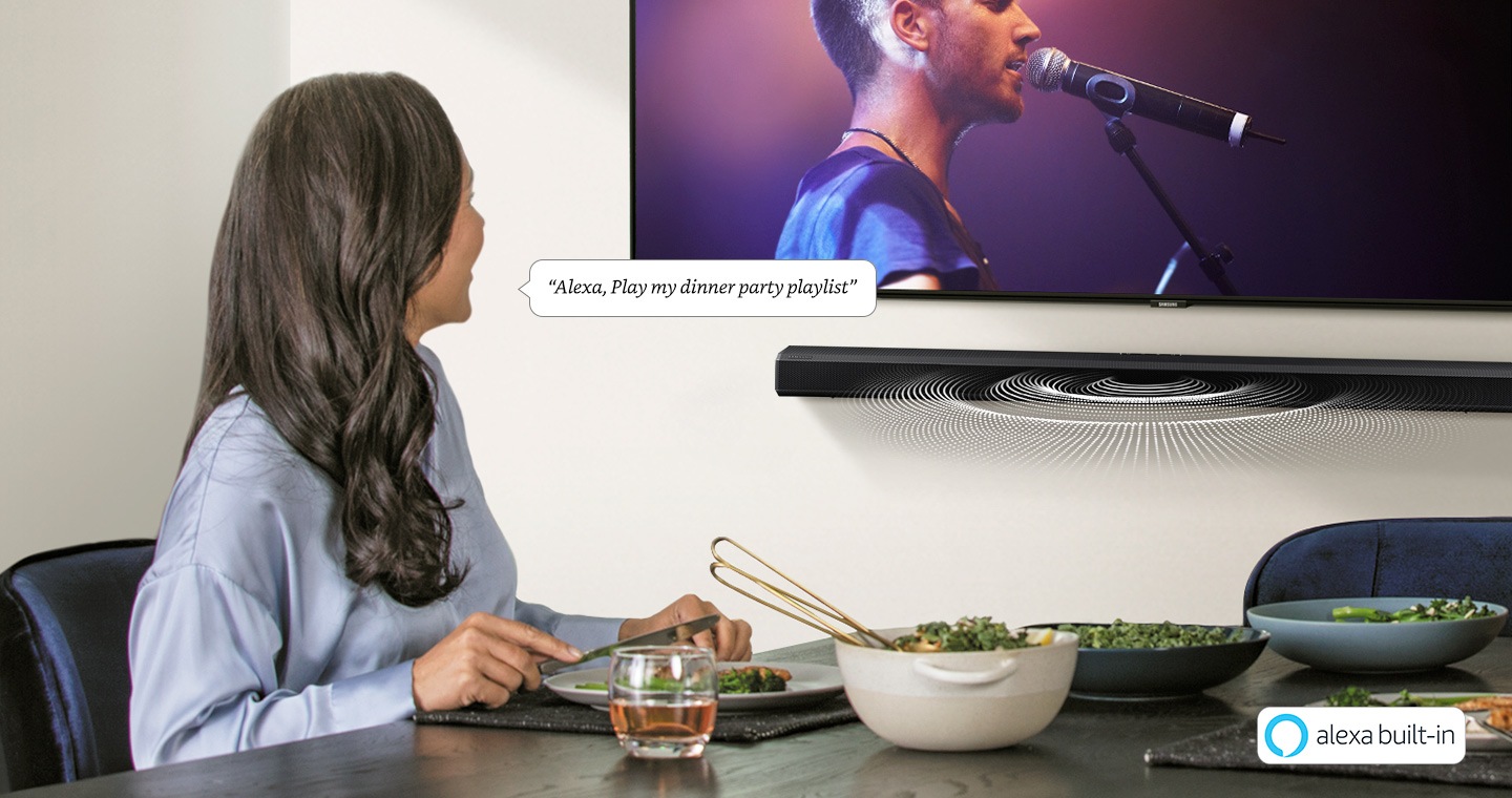 Image of lady sitting in front of a Samsung soundbar with Alexa