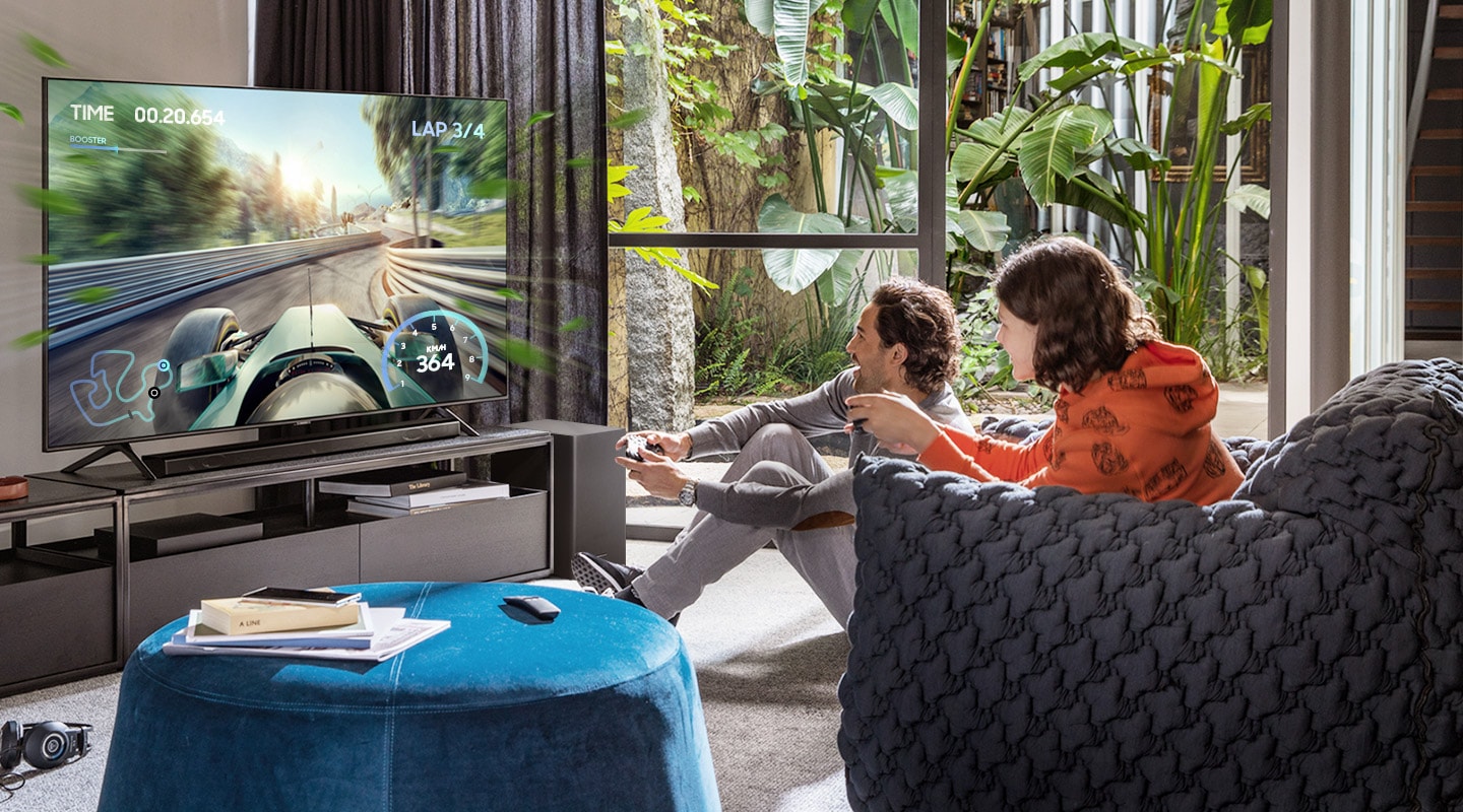 Image of two people playing a game on Samsung QLED tv with a Samsung soundbar