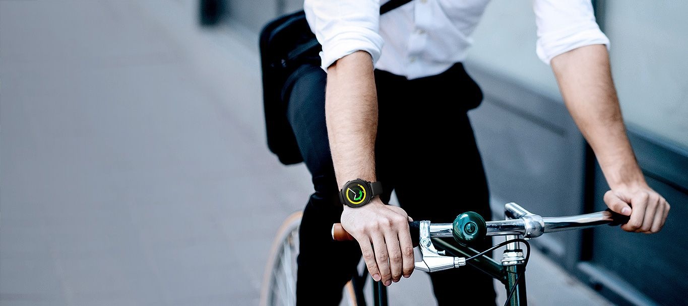 Image of man riding a bike with Gear Sport in black on his wrist