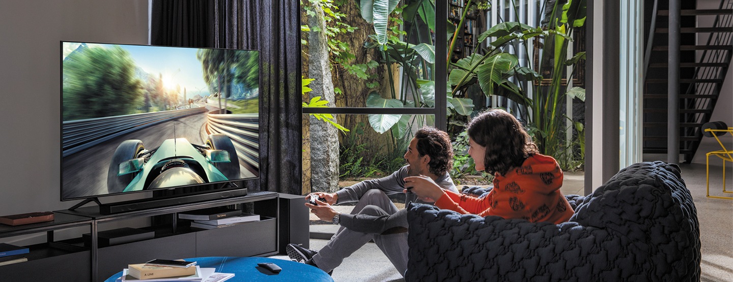 Mother and daughter enjoying moments in front of Samsung TV Mother and daughter enjoying moments in front of Samsung TV