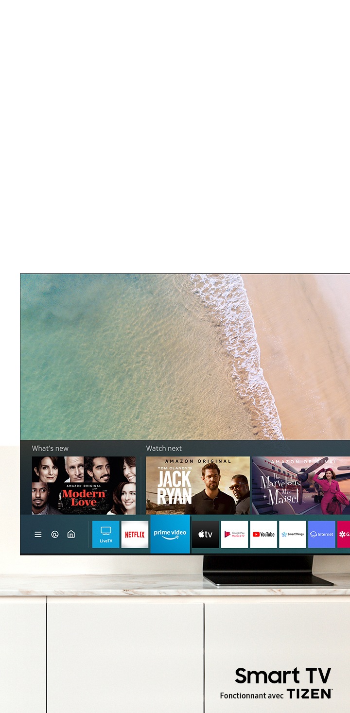 Sur l'écran de la Samsung QLED TV, on voit le Smart Hub et la plate-forme Samsung Smart TV. Le logo Smart TV powered by TIZEN se trouve sous la télévision.