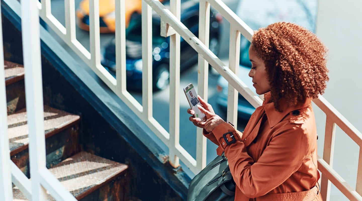 A woman holding her smartphone to find new trends.
